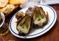 Delicious fried artichoke halves on a white plate Royalty Free Stock Photo