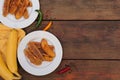 Delicious fried bananas, fresh fruits and different peppers on wooden table, flat lay. Space for text Royalty Free Stock Photo