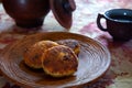 Delicious fried cheesecakes on a clay plate in a rustic setting