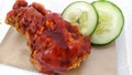 delicious fried chicken with hot sauce served with sliced cucumbers