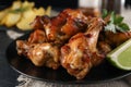 Delicious fried chicken wings on black plate, closeup Royalty Free Stock Photo