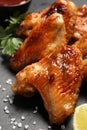 Delicious fried chicken wings and lime on black table, closeup Royalty Free Stock Photo