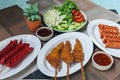 The delicious fried chicken wings and sausages, mixed with flour and seasonings with a delicious spicy sauce and come with Royalty Free Stock Photo