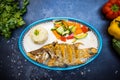 Delicious fried fish, rice, and sliced vegetables on white plate Royalty Free Stock Photo