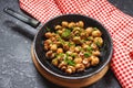 Delicious fried mushrooms in pan on stone table