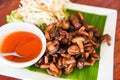 Delicious fried mushrooms in plate on wooden table, top view - cooked shiitake mushrooms fried with tomato sauce and vegetables