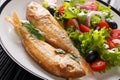 Delicious fried pink dorado with lemon and fresh vegetable salad close-up on a plate. horizontal Royalty Free Stock Photo