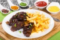 Delicious fried ribs sprinkled with green onion with french fri Royalty Free Stock Photo