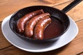 Delicious fried sausages in iron pan Royalty Free Stock Photo