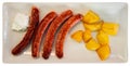 Fried sausages served with potatoes and alioli sauce Royalty Free Stock Photo