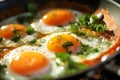 Delicious fried sunny-side-up eggs in a pan seasoned with salt ground pepper and fresh herbs. Healthy nutritious breakfast