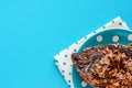 Delicious fried Tilapia fish in polka dot plate on blue background