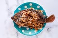 Delicious fried Tilapia fish in polka dot plate on marble background