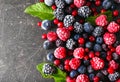 Delicious frozen berries on grey background