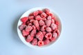 Delicious frozen raspberries in a white bowl. Royalty Free Stock Photo