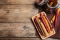 Delicious fruit leather rolls on wooden table, flat lay. Space for text