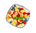 Delicious fruit salad in glass bowl on white background Royalty Free Stock Photo