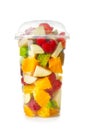 Delicious fruit salad in plastic cup on white background Royalty Free Stock Photo