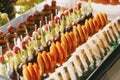 Delicious fruits appetizers, desserts on stand, modern sweet table at wedding or baby shower. Luxury catering concept. Fruit bar