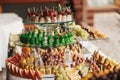 Delicious fruits appetizers, desserts on stand, modern sweet table at wedding or baby shower. Luxury catering concept. Fruit bar Royalty Free Stock Photo