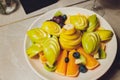 Delicious fruits salad in plate on table close-up. Royalty Free Stock Photo