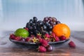 Delicious fruits salad in plate on table, lime, raspberry, grapes Royalty Free Stock Photo