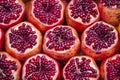 Delicious fruits on a stall, variety of healthy ripe fruits cut pomegranates, top view, pomegranate background