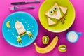 Delicious funny sandwiches in shapes of owl and rocket on plates for breakfast