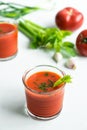 Delicious gaspacho soup in glasses, ingredients on white background Royalty Free Stock Photo