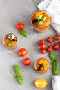 Delicious gazpacho soup in glass. Traditional spanish cold soup puree gaspacho garnish with tomato, cucumber and basil. Grey Royalty Free Stock Photo