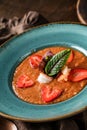 Delicious gazpacho soup with shrimps, strawberries and cucumber in bowl over brown wooden background. Healthy food, clean eating Royalty Free Stock Photo