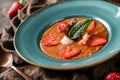 Delicious gazpacho soup with shrimps, strawberries and cucumber in bowl over brown wooden background. Healthy food, clean eating, Royalty Free Stock Photo