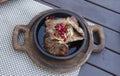Delicious Georgian cuisine. fried meat in a clay pan, served with onions and pomegranate seeds