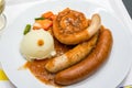 A delicious German meat sausage platter with mashed potatoes