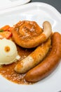 A delicious German meat sausage platter with mashed potatoes