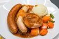 A delicious German meat sausage platter with mashed potatoes