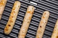 Delicious german sausages on the barbecue electro grill. Tasty sausages sizzling on a portable electric grilling on a summer Royalty Free Stock Photo