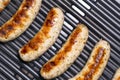 Delicious german sausages on the barbecue electro grill. Tasty sausages sizzling on a portable electric grilling on a summer Royalty Free Stock Photo