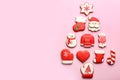 Delicious gingerbread cookies arranged in shape of Christmas tree on pink background, flat lay. Space for text Royalty Free Stock Photo