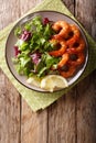 Delicious glazed shrimps with honey and soy sauce and fresh salad close-up. Vertical top view Royalty Free Stock Photo