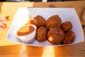 delicious golden brown crab cake platter with red dipping sauce