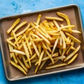 Delicious golden fries arranged on a kraft baking sheet