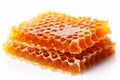 Delicious golden honey and beautifully patterned honeycomb isolated on a pure white background