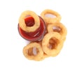 Delicious golden onion rings with ketchup isolated, top view Royalty Free Stock Photo