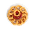 Delicious golden onion rings with ketchup isolated, top view Royalty Free Stock Photo