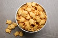 Delicious goldfish crackers in bowl on table, flat lay