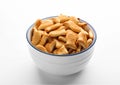 Delicious goldfish crackers in bowl isolated on white Royalty Free Stock Photo