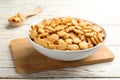 Delicious goldfish crackers in bowl on wooden table