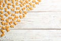 Delicious goldfish crackers on white table, flat lay. Space for text Royalty Free Stock Photo