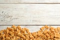 Delicious goldfish crackers on wooden table, flat lay. Space for text Royalty Free Stock Photo